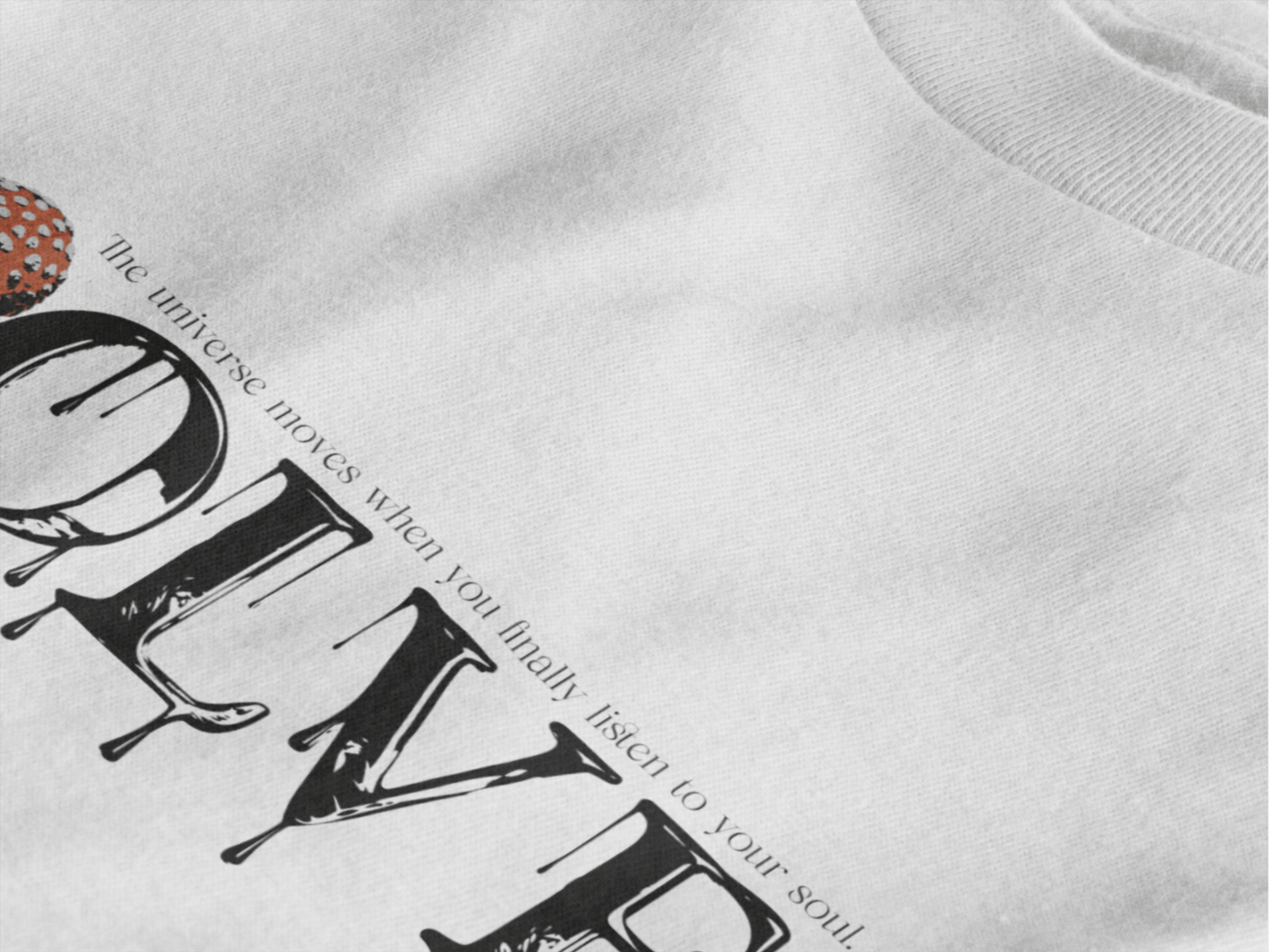 A white t-shirt with the graphic design 'EVOLVE - the universe moves when you finally listen to your soul.' on a black background